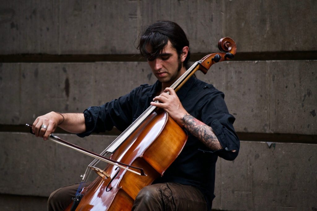 musician or songwriter playing the cello